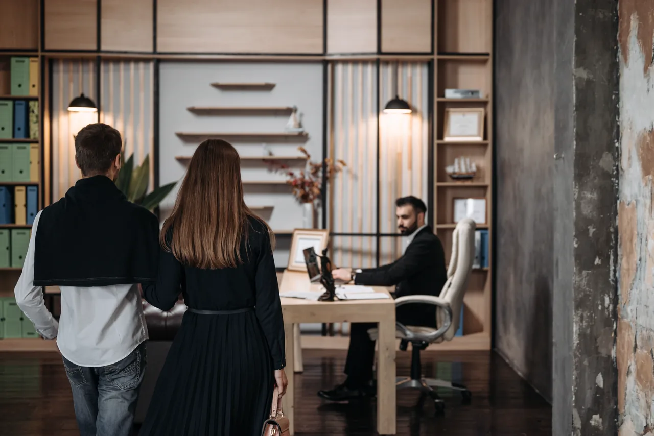 A lawyer meeting a couple in his office